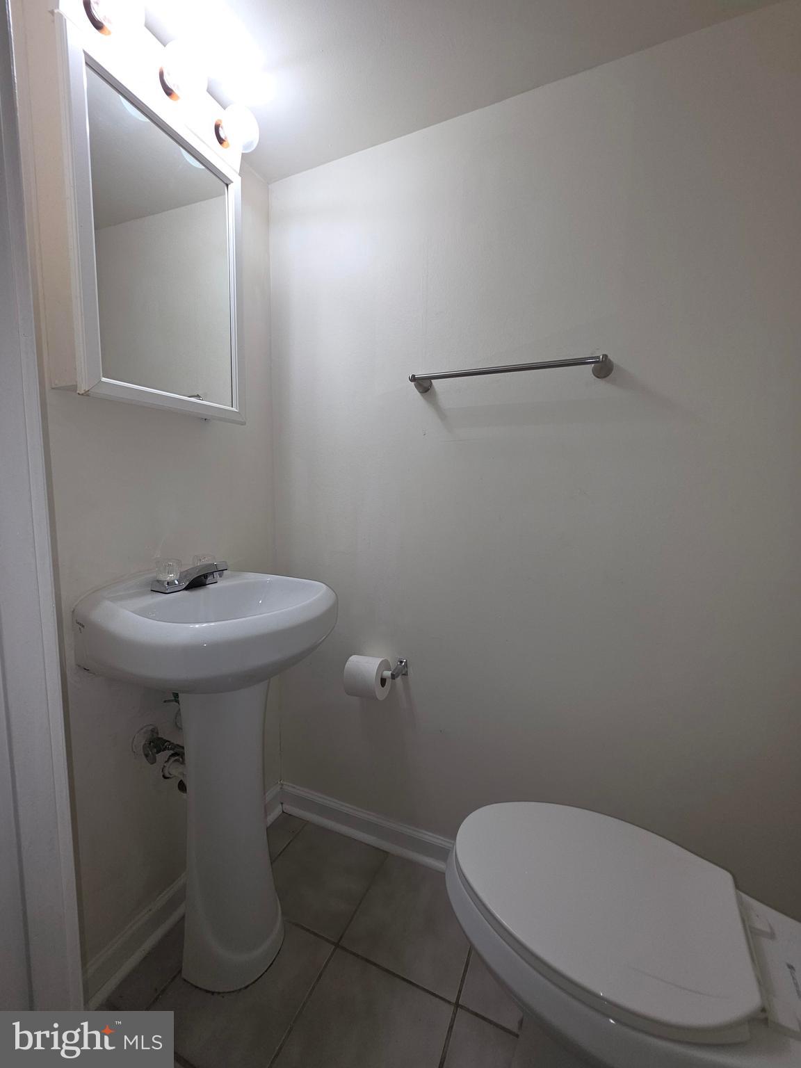 5407 Fallriver Row Court Columbia, MD 21044 - Photo 11 of 36 a bathroom with a toilet sink and mirror