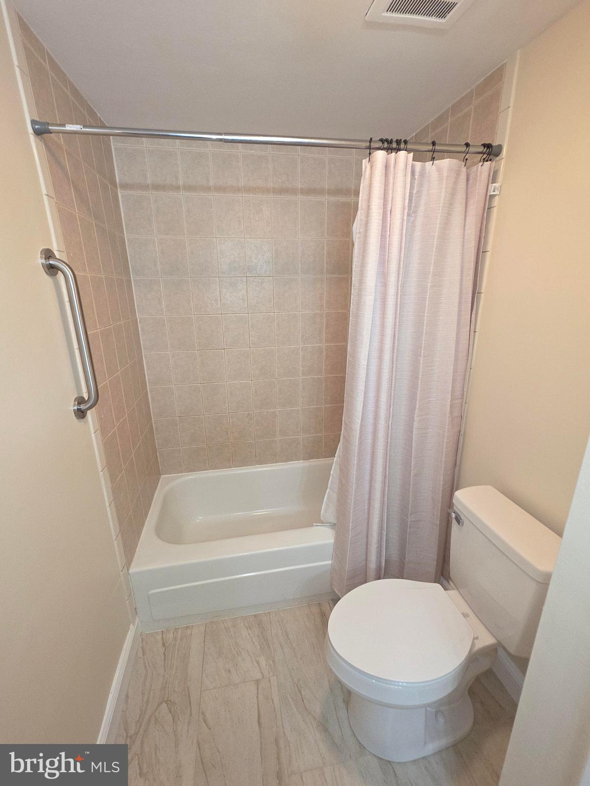 5407 Fallriver Row Court Columbia, MD 21044 - Photo 19 of 36 a bathroom with a toilet and a shower curtain