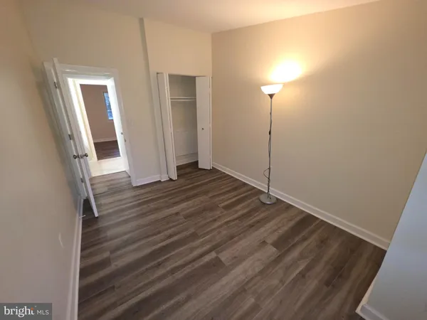 a view of a room with wooden floor and brick wall