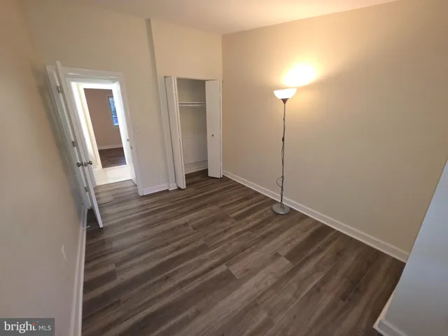 a view of a room with wooden floor and brick wall