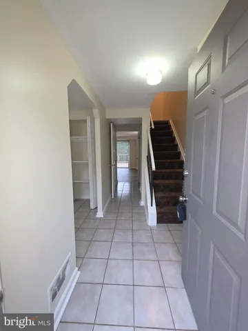 a view of an empty room with stairs and ventilation