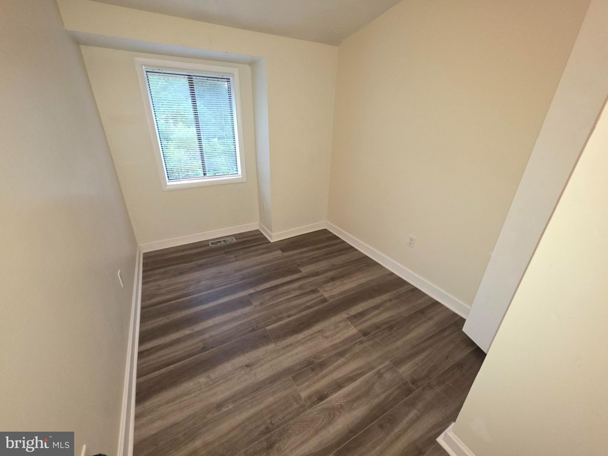 5407 Fallriver Row Court Columbia, MD 21044 - Photo 21 of 36 a view of an empty room with wooden floor and a window
