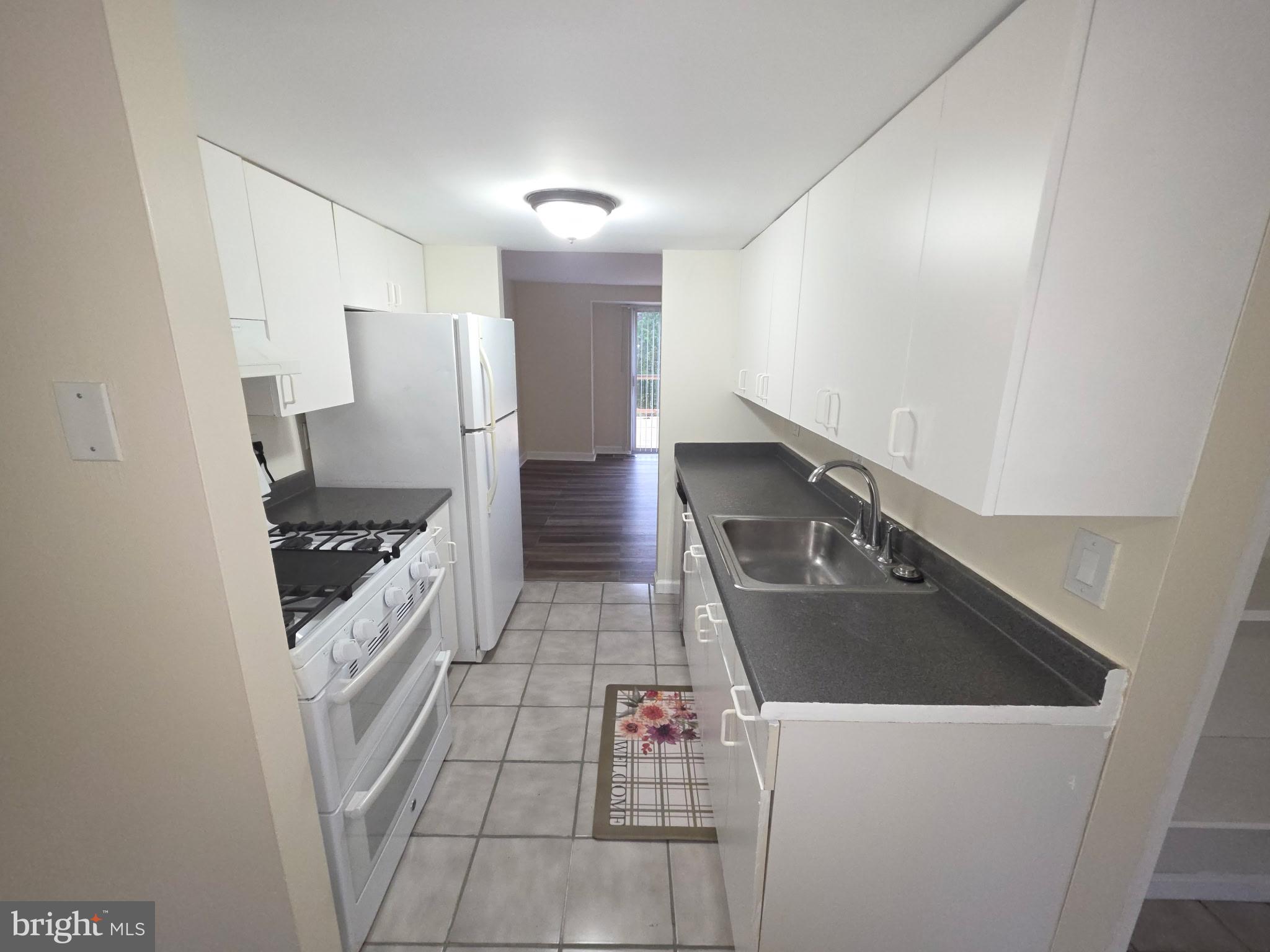 5407 Fallriver Row Court Columbia, MD 21044 - Photo 6 of 36 a kitchen with stainless steel appliances granite countertop a sink a stove and a refrigerator