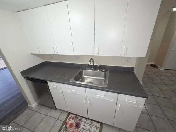 a kitchen with a sink and cabinets