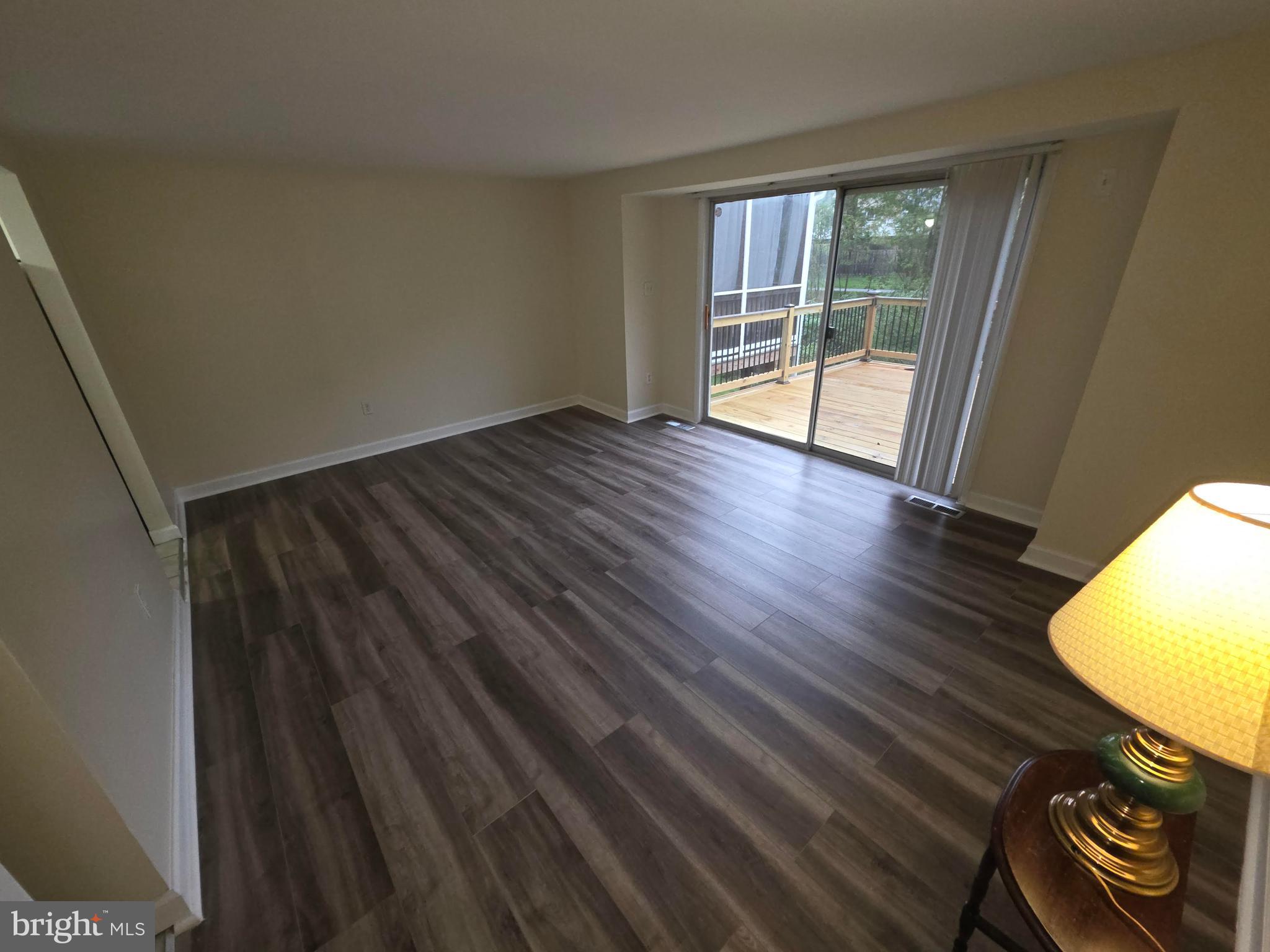 5407 Fallriver Row Court Columbia, MD 21044 - Photo 9 of 36 wooden floor in an empty room with a window