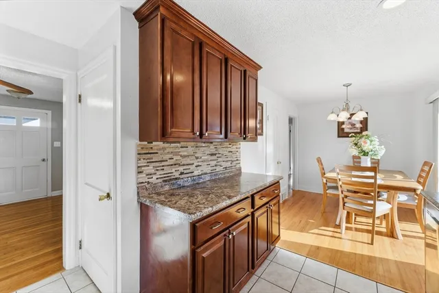 an entryway with wooden floor and dining room view