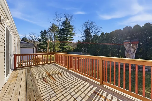 a view of balcony with wooden floor and fence