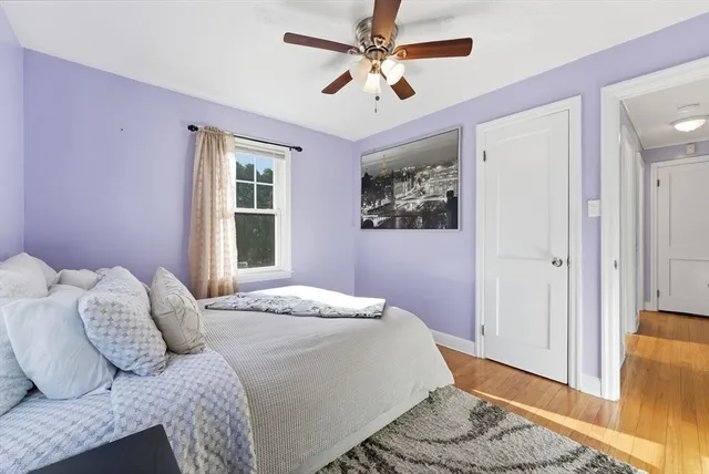 a bedroom with a large bed and a window