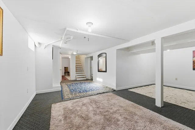 a spacious bathroom with a granite countertop sink and a mirror