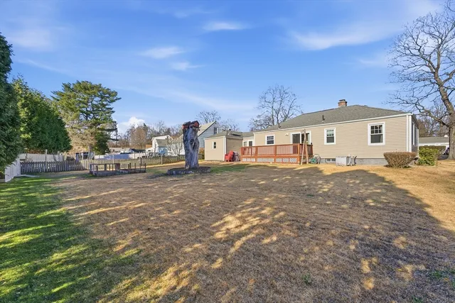 a view of a white house with a yard