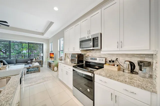a kitchen with appliances a sink a stove and cabinets