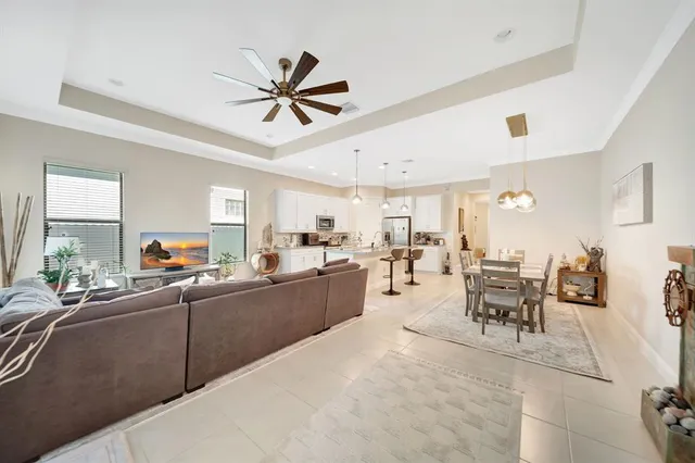 a living room with furniture kitchen area and a window