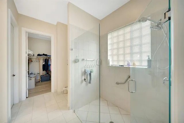 a bathroom with a granite countertop shower mirror and a sink