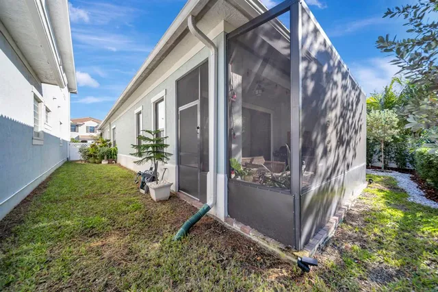 a view of backyard with large trees and plants