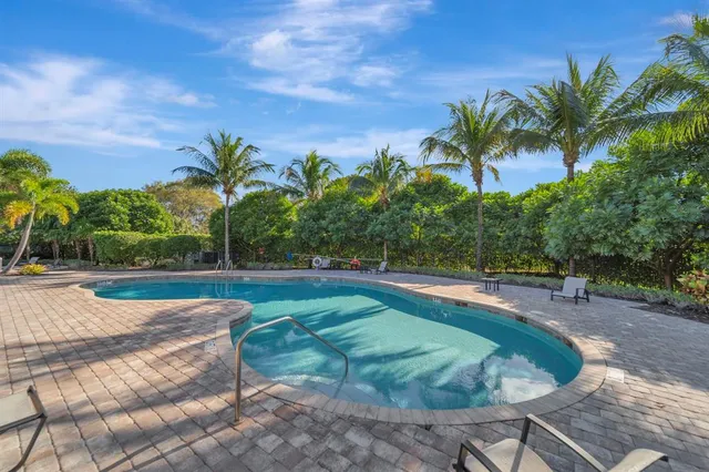 a view of a swimming pool with chairs
