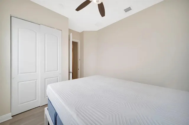 a view of a livingroom with a ceiling fan and wooden floor