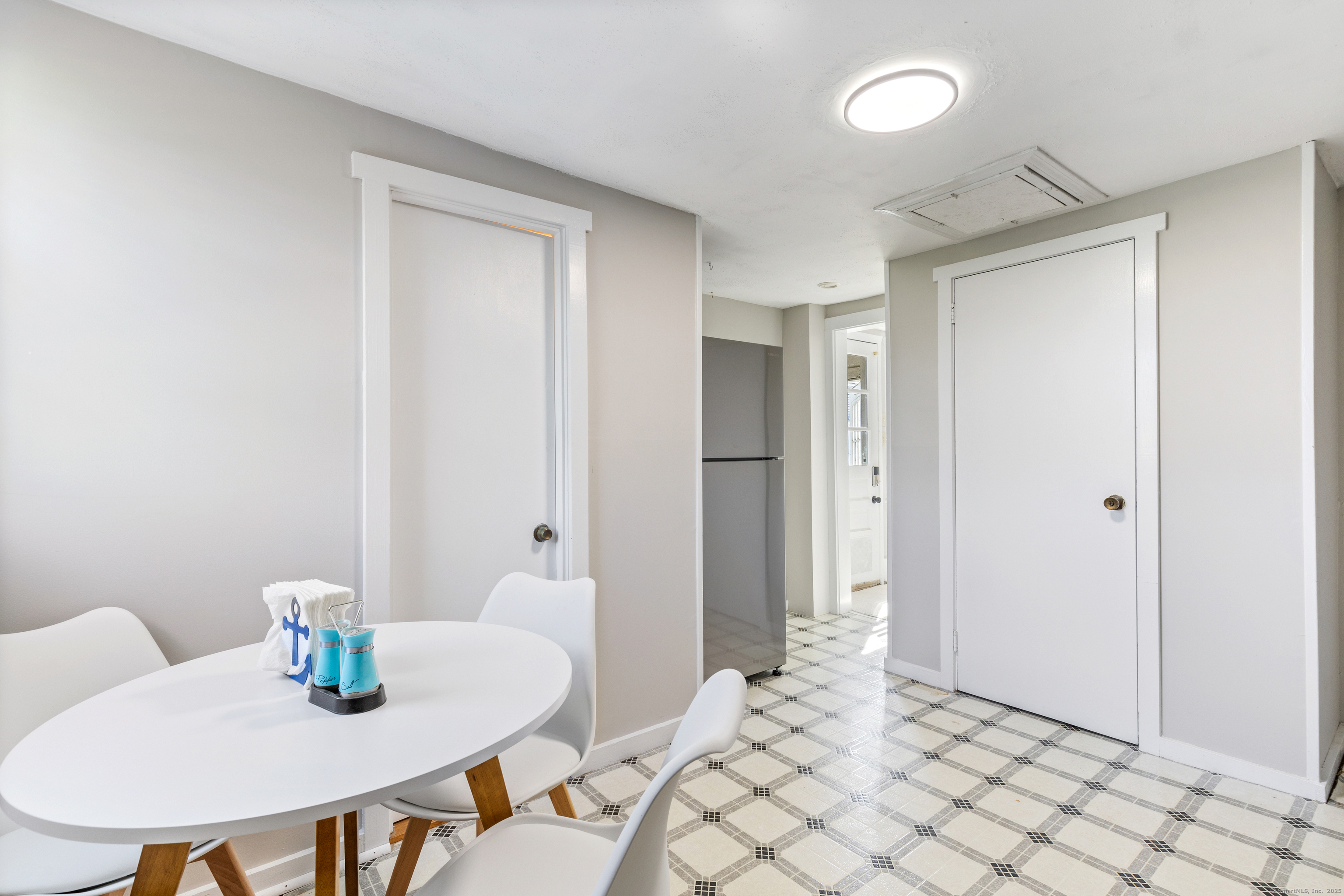 176 Shore Road, Unit B Clinton, CT 06413 - Photo 17 of 24 a view of a dining room with furniture and wooden floor