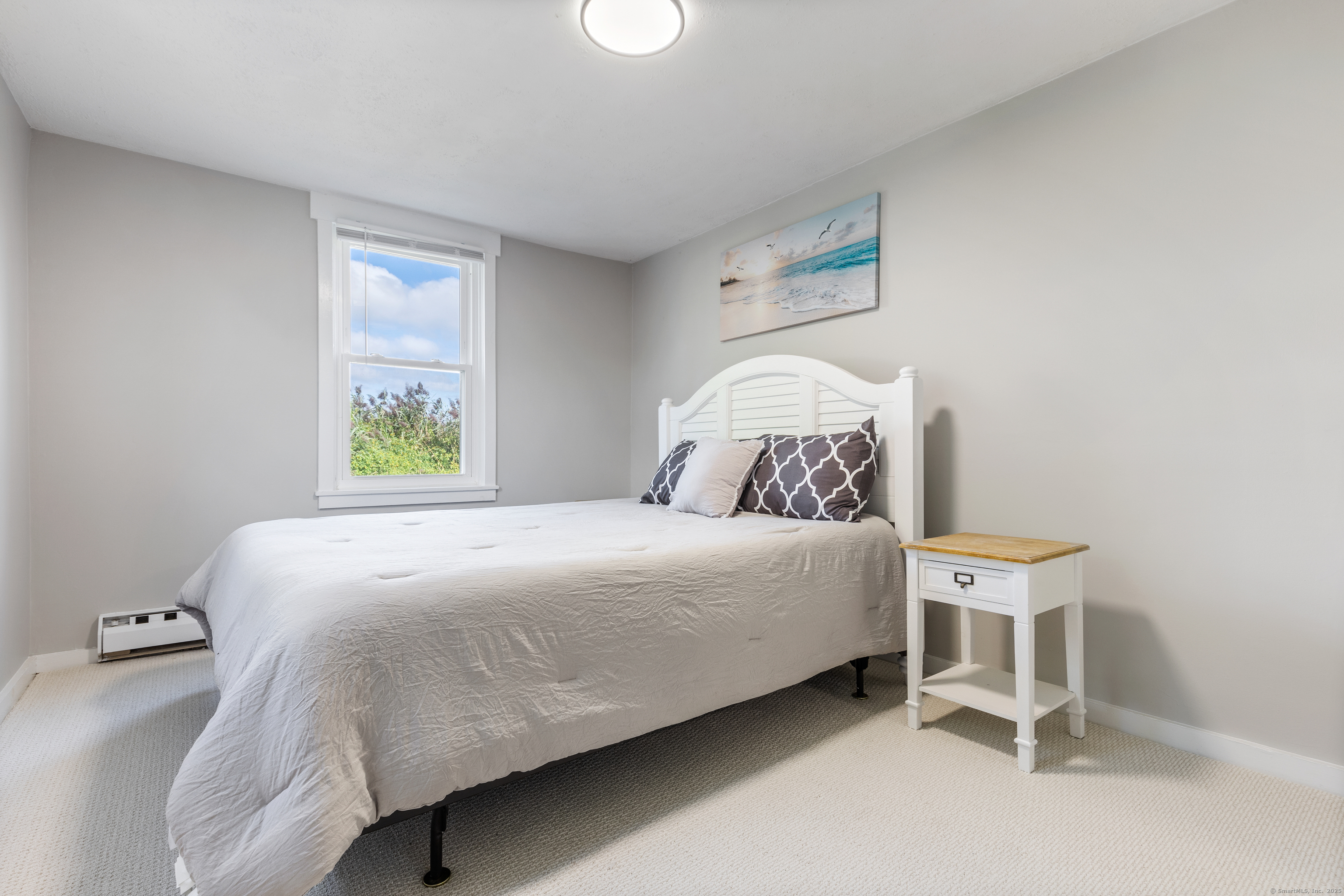 176 Shore Road, Unit B Clinton, CT 06413 - Photo 18 of 24 a bedroom with a bed and a window