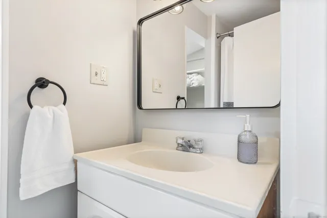 a bathroom with a sink and a mirror