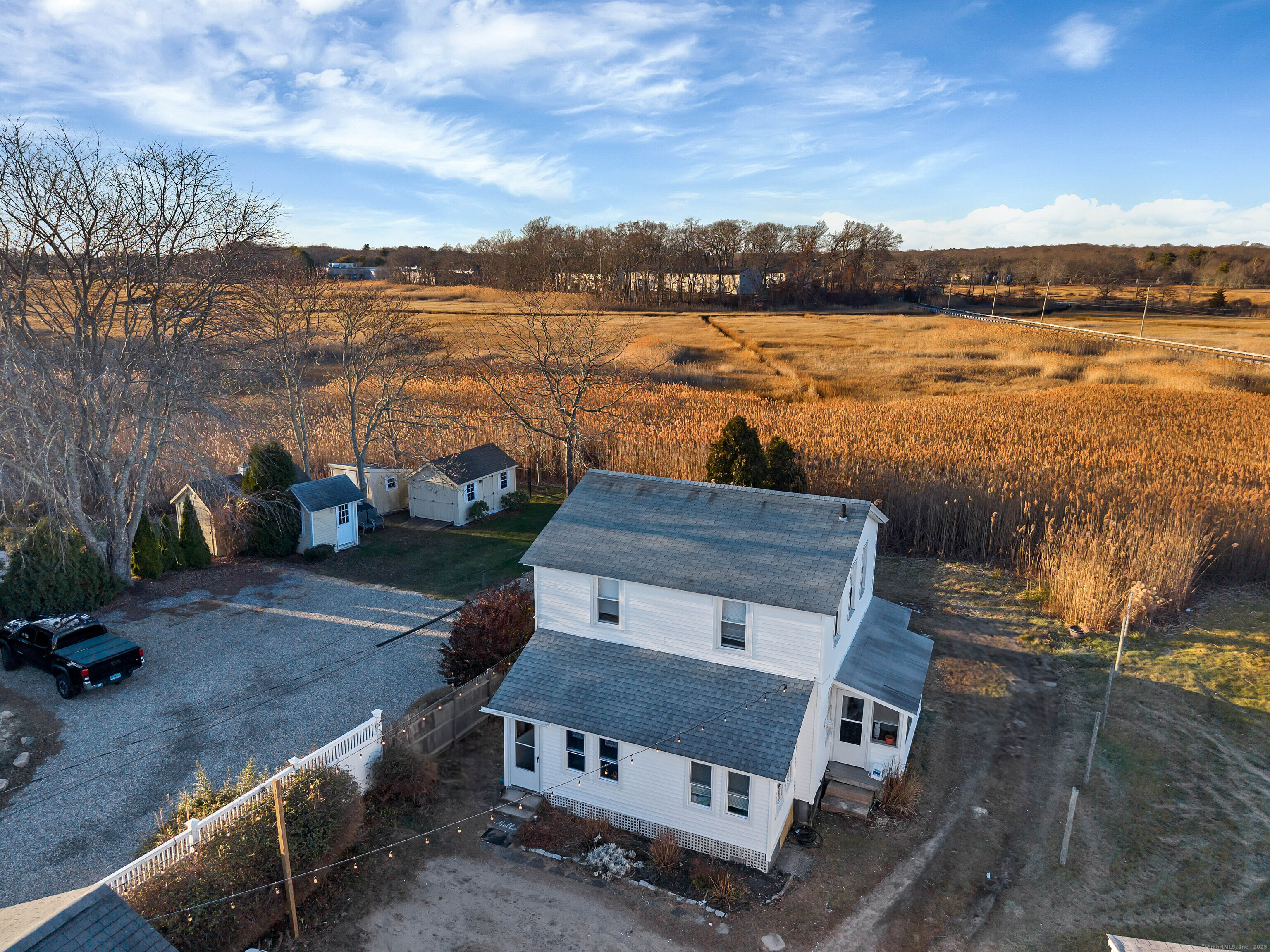 176 Shore Road, Unit B Clinton, CT 06413 - Photo 9 of 24 a wooden deck with lake view and mountain view