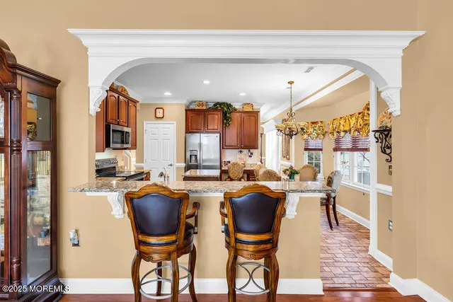 a living room with furniture a fireplace and a large window