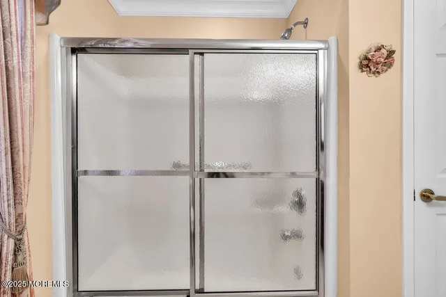 a view of a house with a yard and a large tree