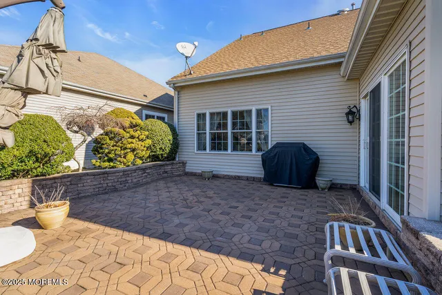 an aerial view of a city with lots of residential buildings ocean and mountain view in back