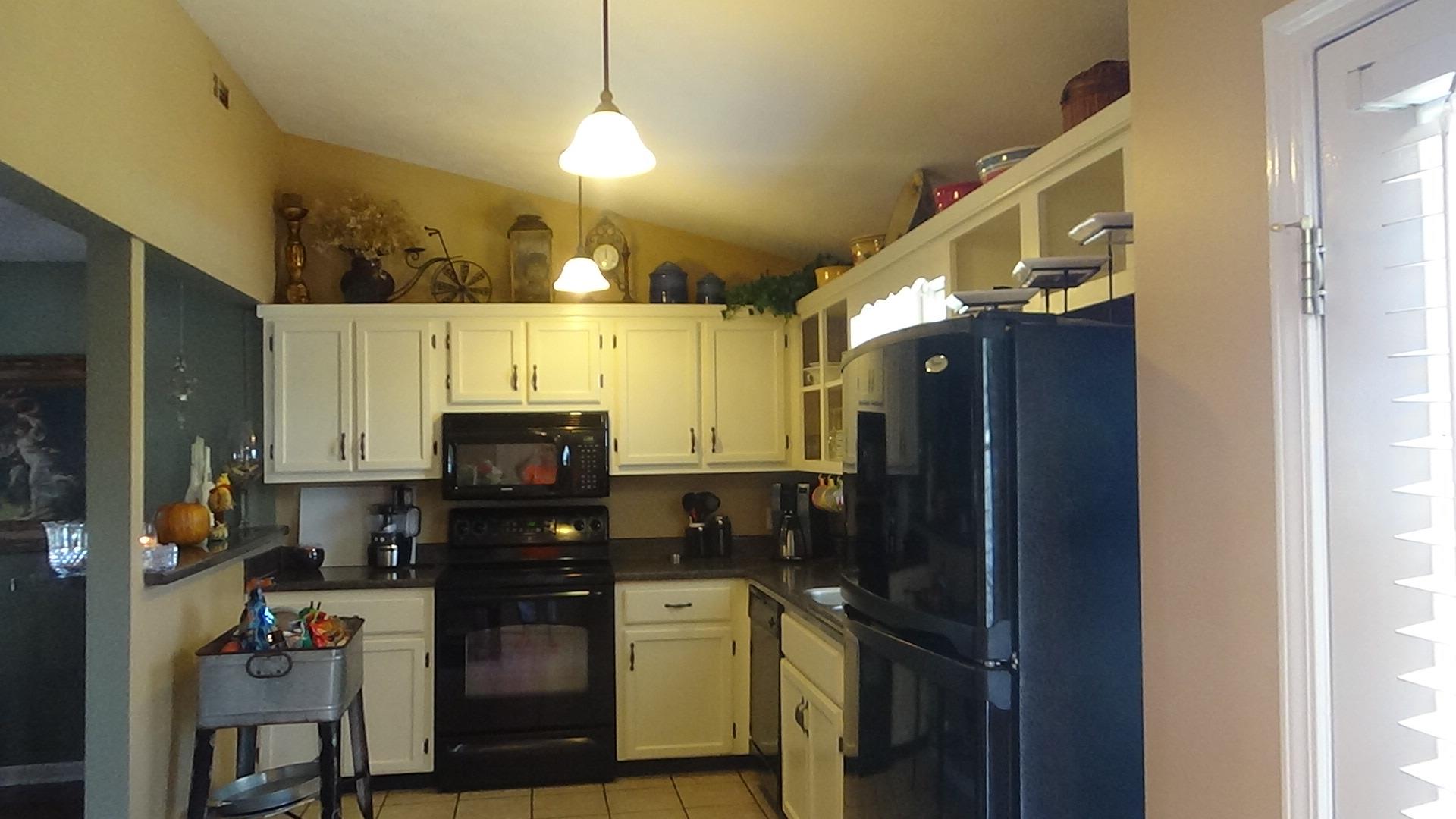 1126 Maxwell Branch Road Cottontown, TN 37048 - Photo 12 of 27 a kitchen with a refrigerator and a stove top oven