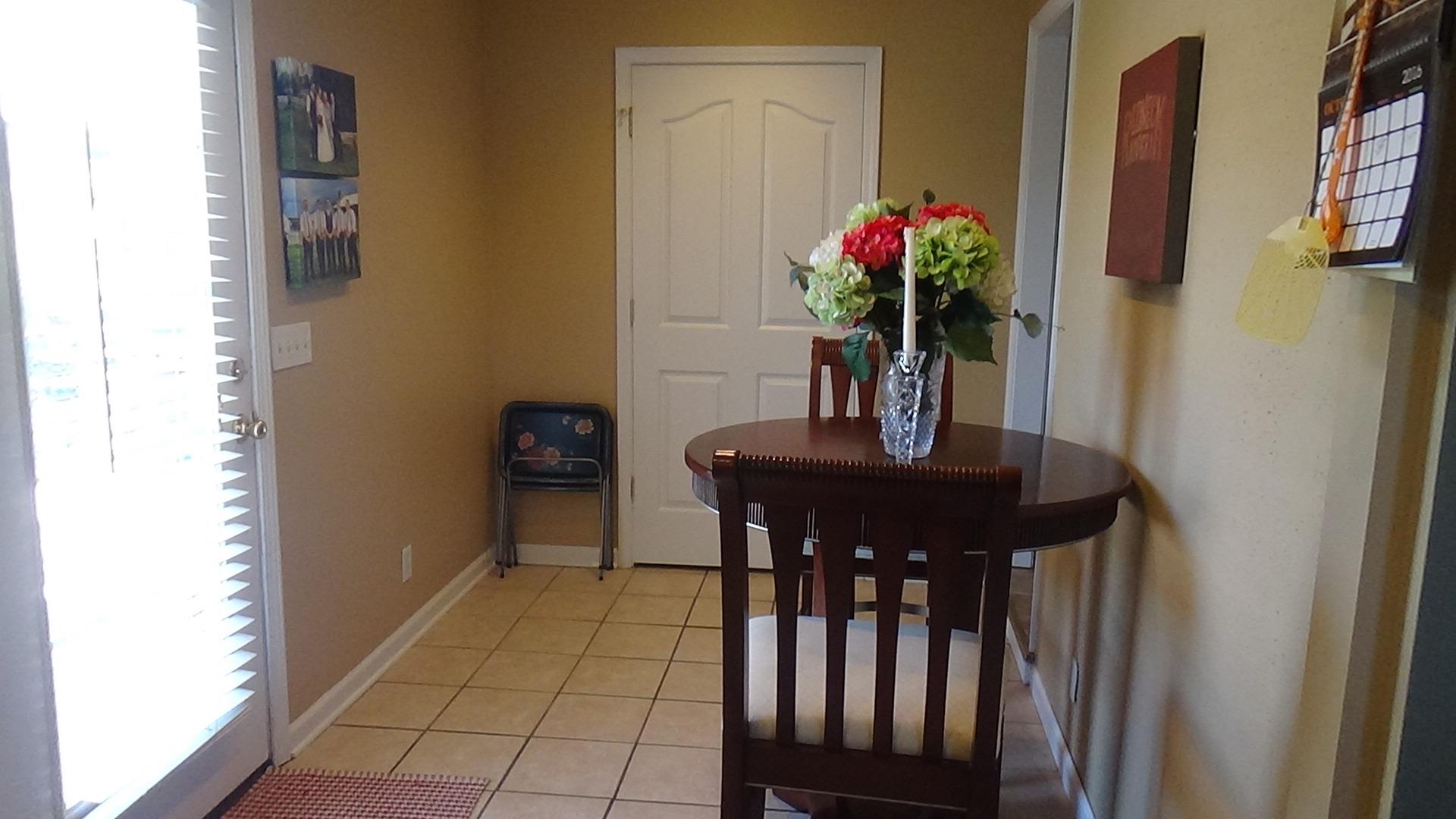 1126 Maxwell Branch Road Cottontown, TN 37048 - Photo 13 of 27 a dining room with furniture and flowers