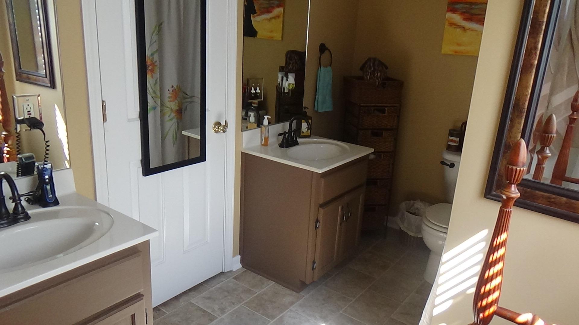 1126 Maxwell Branch Road Cottontown, TN 37048 - Photo 17 of 27 a bathroom with a sink and mirror with bathtub