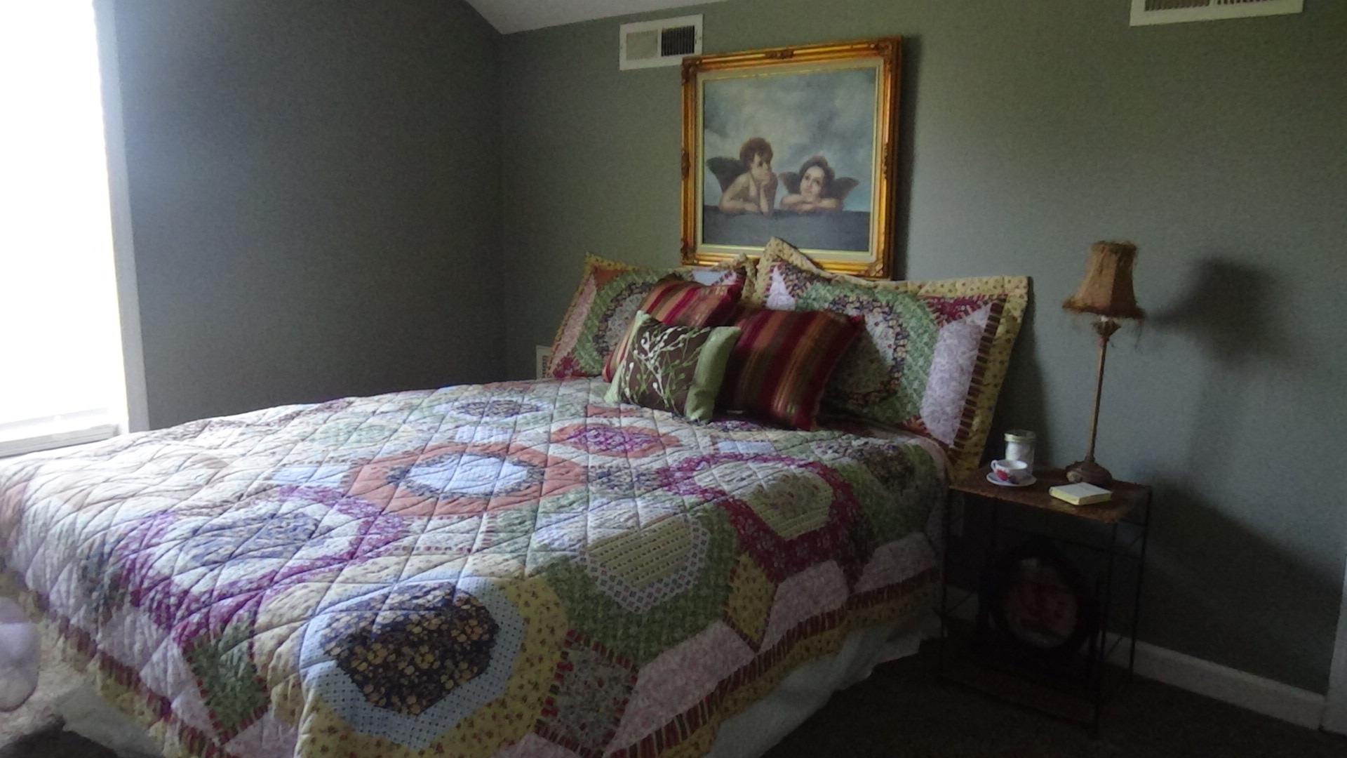 1126 Maxwell Branch Road Cottontown, TN 37048 - Photo 21 of 27 a bedroom with a bed and a painting on the wall