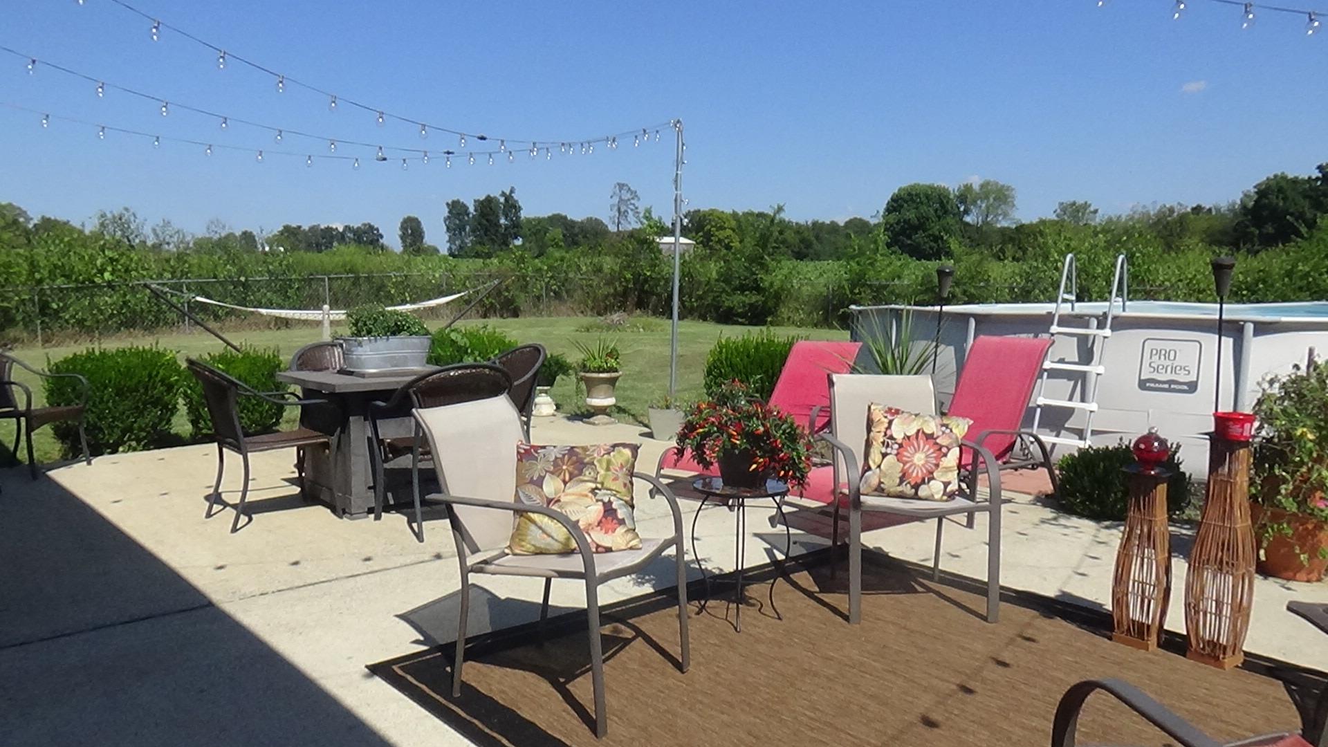 1126 Maxwell Branch Road Cottontown, TN 37048 - Photo 22 of 27 a view of an chairs and tables in patio