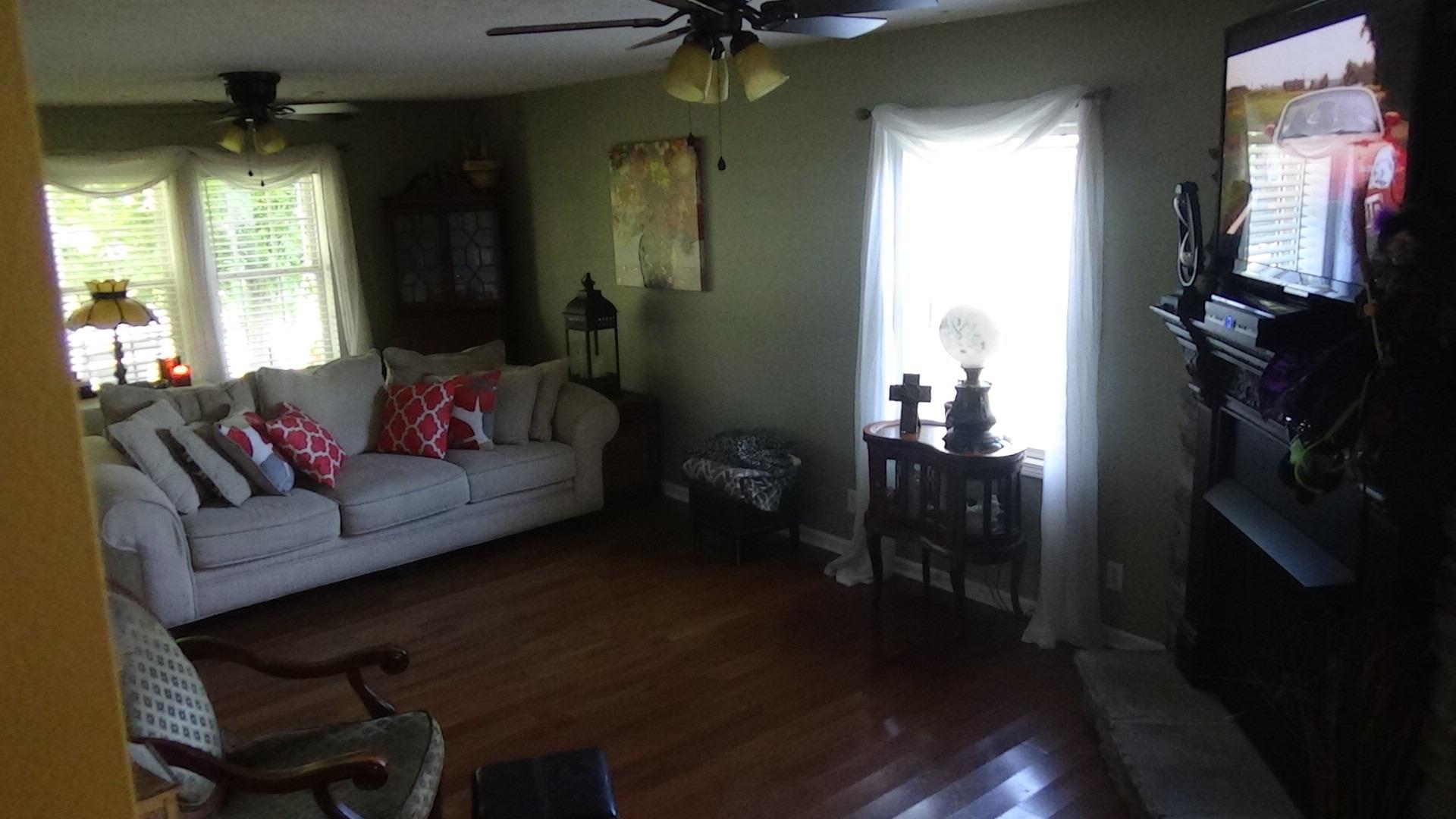 1126 Maxwell Branch Road Cottontown, TN 37048 - Photo 7 of 27 a living room with furniture and a chandelier