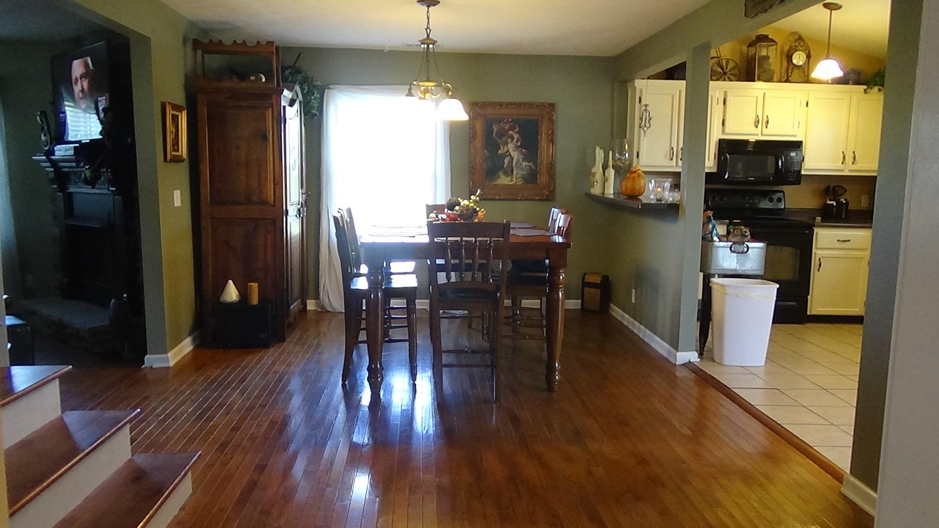 1126 Maxwell Branch Road Cottontown, TN 37048 - Photo 9 of 27 a view of a dining room with furniture window and wooden floor