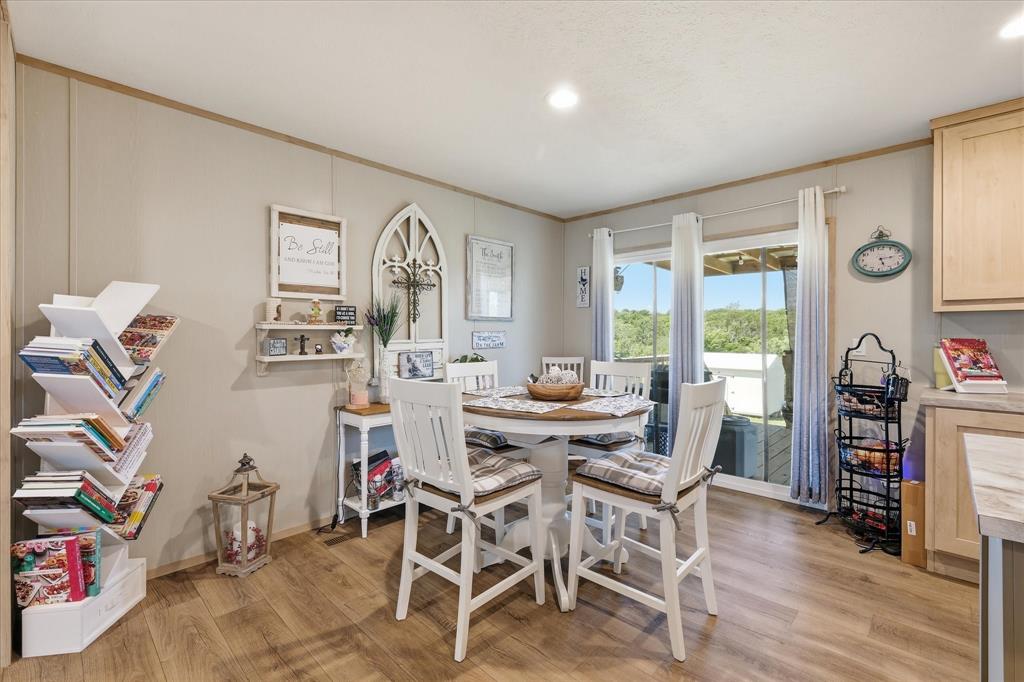193 Firefly Drive Springtown, TX 76082 - Photo 10 of 32 Open concept dining area with wood-finish flooring, recessed lighting, and a large sliding glass door