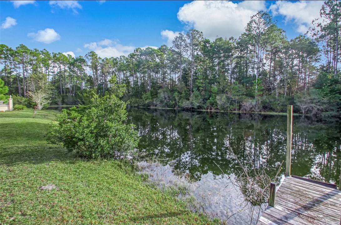 96372 Green Pine Road Yulee, FL 32097 - Photo 23 of 28 a backyard of a house with lots of green space and outdoor seating