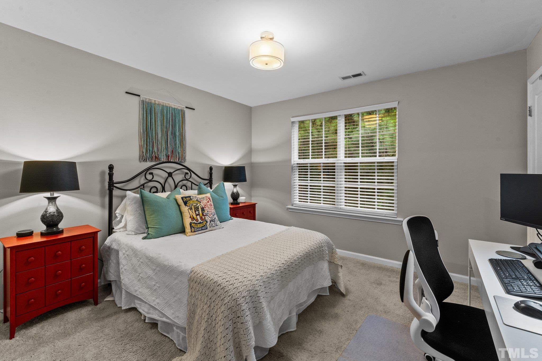 7882 Spungold Street Raleigh, NC 27617 - Photo 15 of 27 a bedroom with a bed and a window