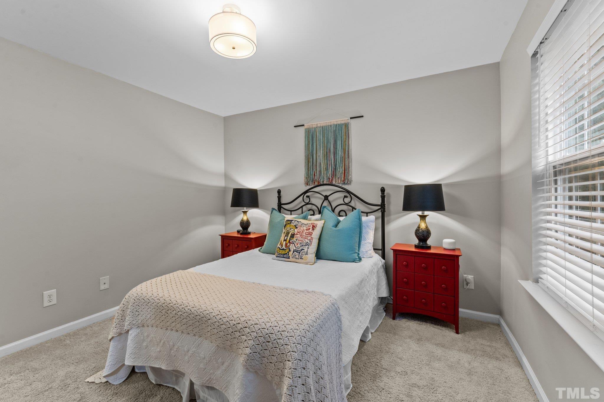 7882 Spungold Street Raleigh, NC 27617 - Photo 16 of 27 a bedroom with a bed and a window