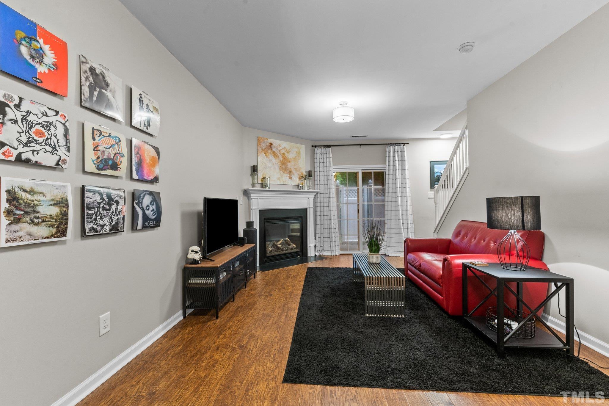 7882 Spungold Street Raleigh, NC 27617 - Photo 20 of 27 a living room with furniture and a flat screen tv