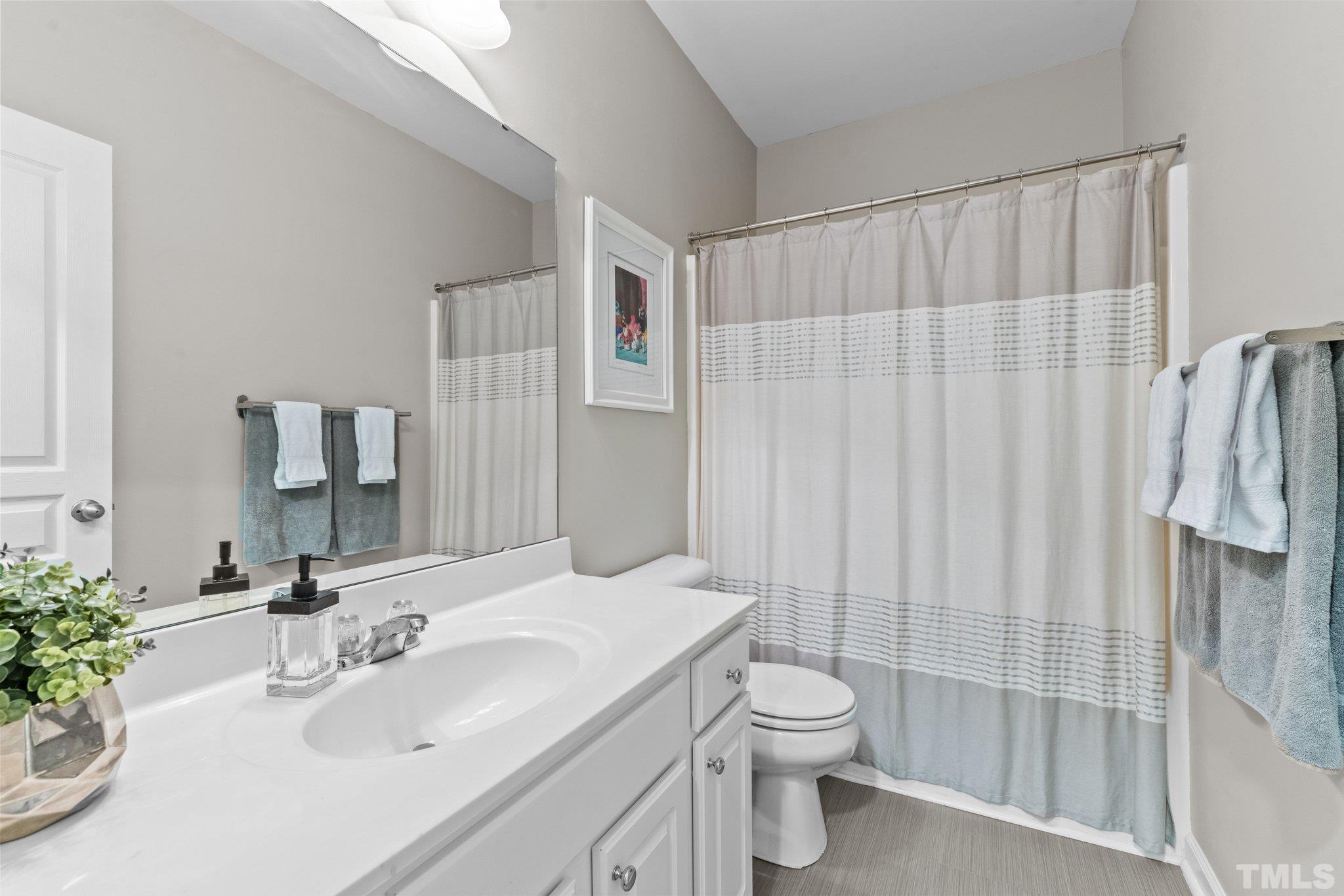 7882 Spungold Street Raleigh, NC 27617 - Photo 22 of 27 a bathroom with a sink toilet and shower