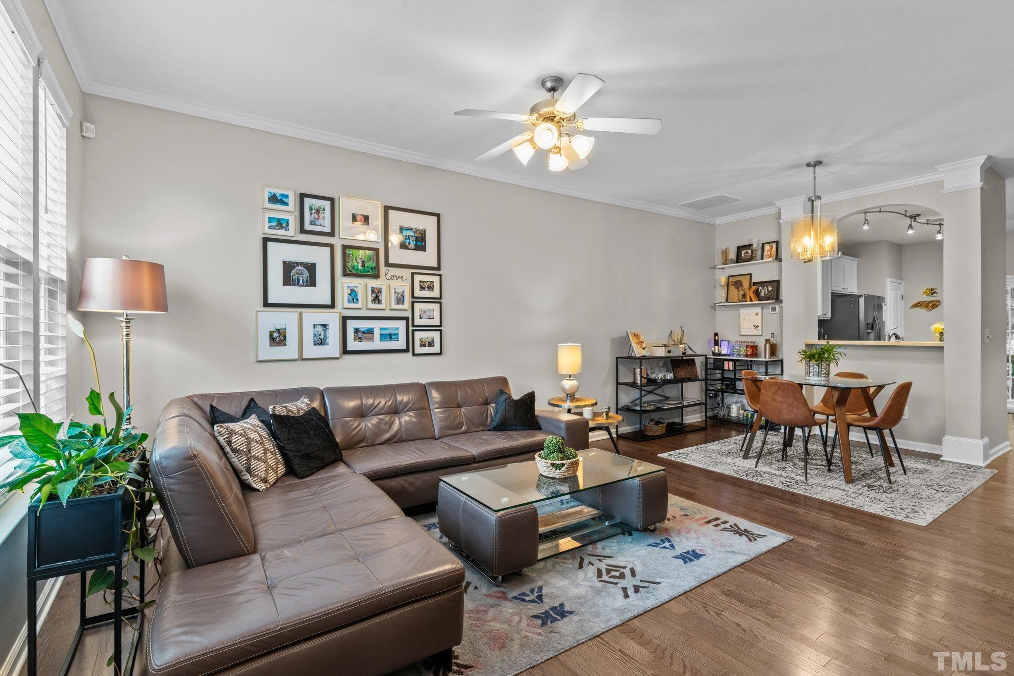 7882 Spungold Street Raleigh, NC 27617 - Photo 3 of 27 a living room with furniture potted plant and a window