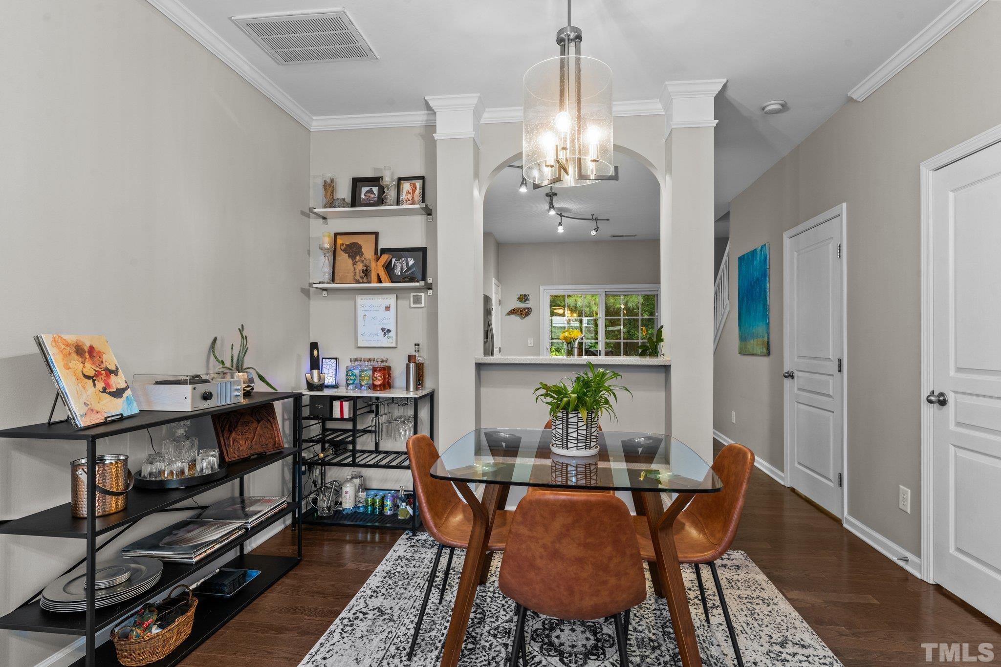 7882 Spungold Street Raleigh, NC 27617 - Photo 5 of 27 a living room with furniture and a chandelier