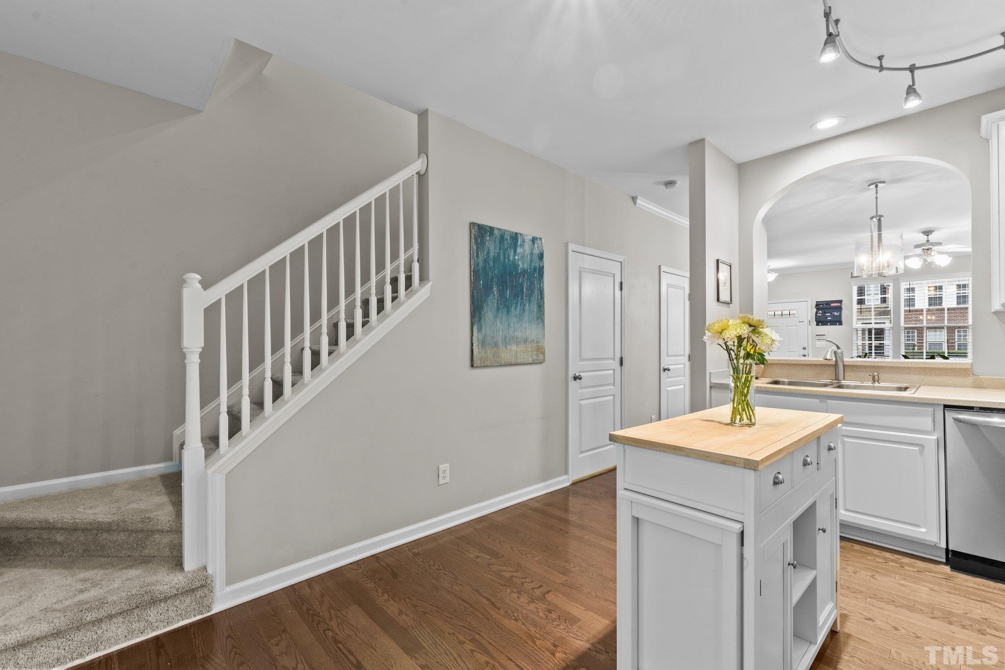 7882 Spungold Street Raleigh, NC 27617 - Photo 9 of 27 a room with chandelier fan and wooden floor