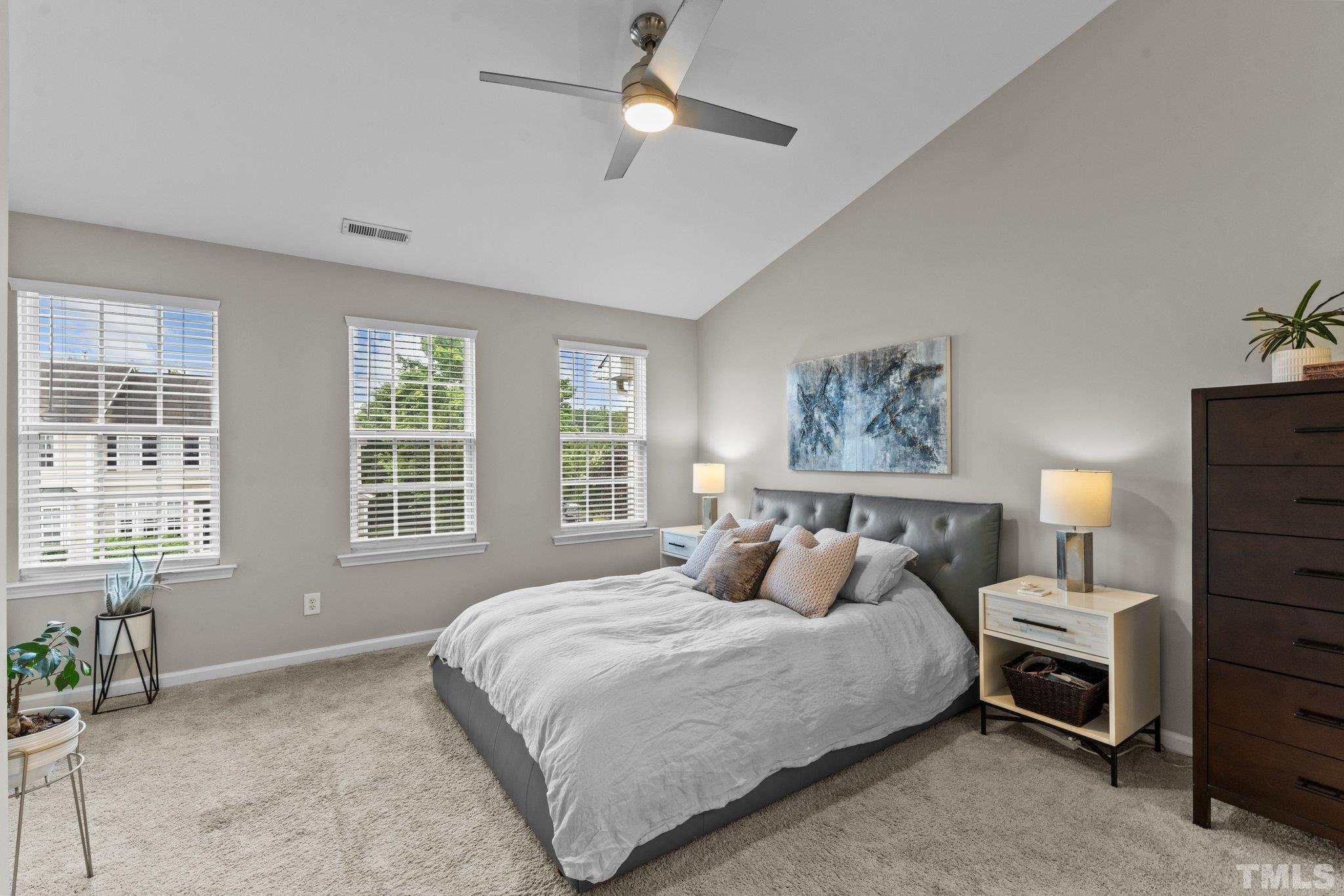 7882 Spungold Street Raleigh, NC 27617 - Photo 10 of 27 a bedroom with a bed and a table