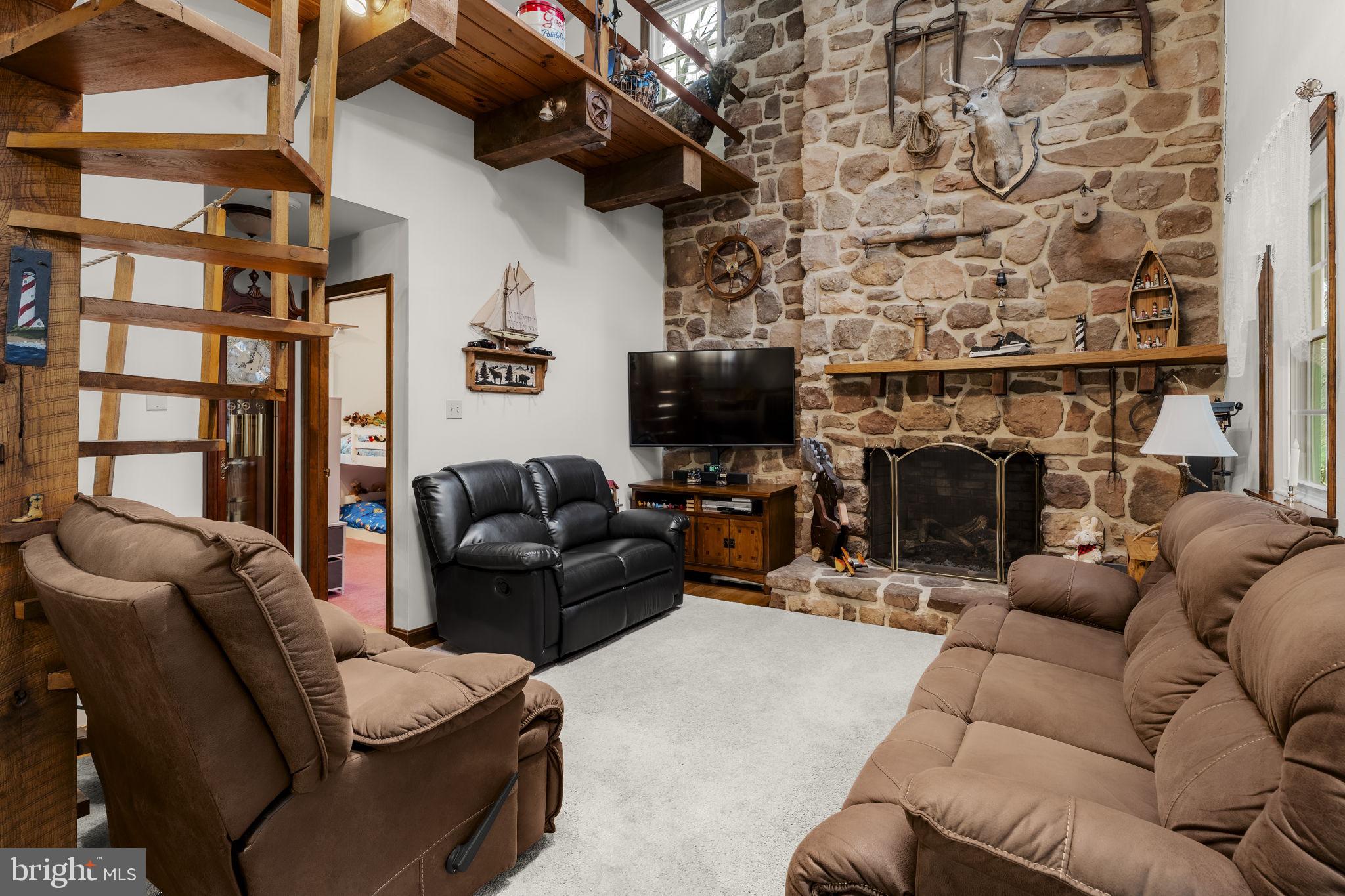 1195 Seglock Road Stevens, PA 17578 - Photo 3 of 33 a living room with furniture a flat screen tv and a fireplace