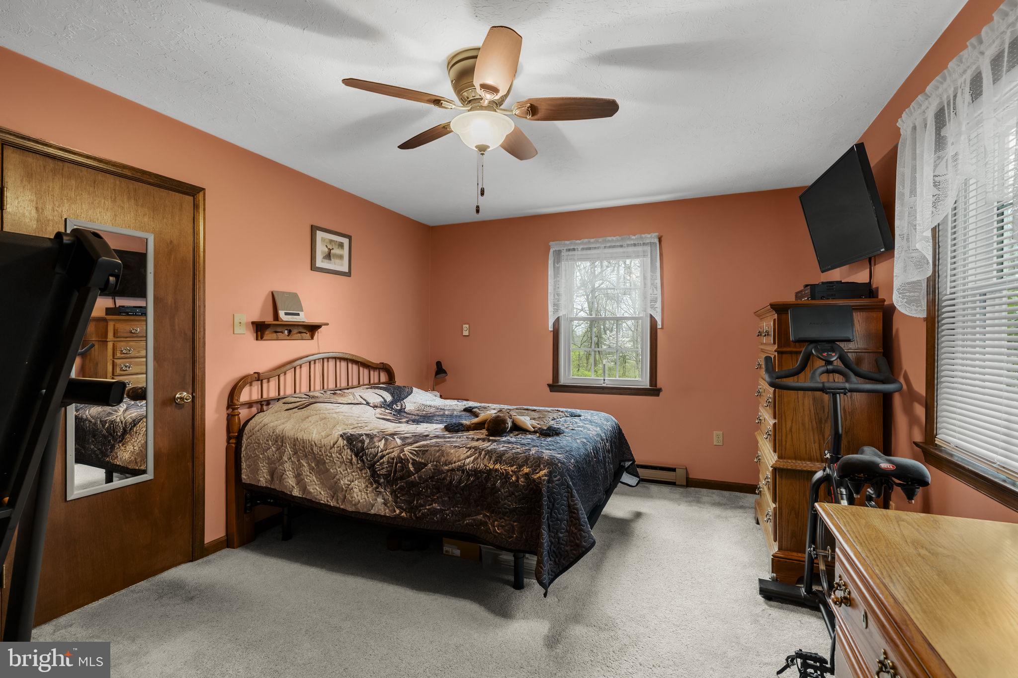 1195 Seglock Road Stevens, PA 17578 - Photo 10 of 33 a bedroom with a bed and a flat tv screen