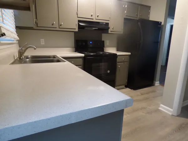 a kitchen with a refrigerator and a sink