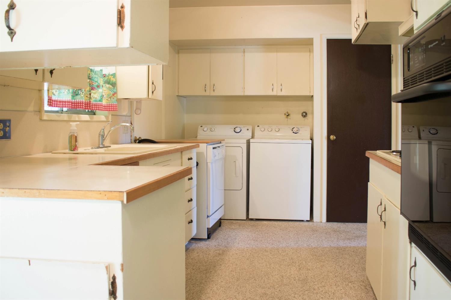 2613 Table Rock Road Medford, OR 97501 - Photo 4 of 23 a utility room with cabinets washer and dryer