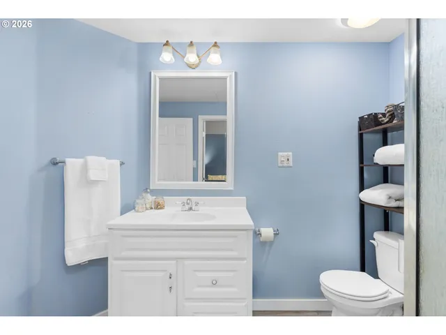 a bathroom with a sink toilet and mirror