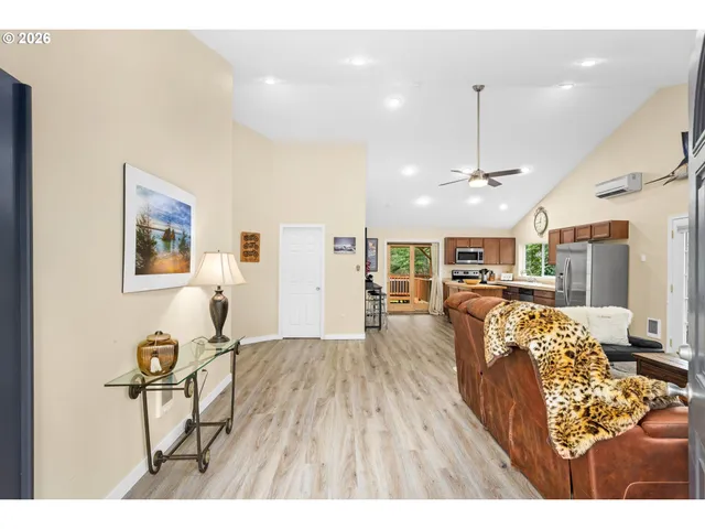 a view of a living room and kitchen with furniture wooden floor